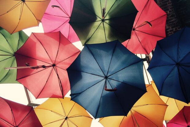 Many umbrellas are open and photographed from underneath.