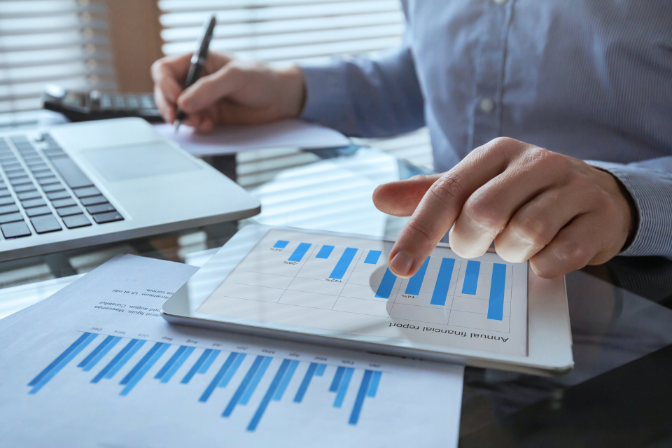 A person looking at financial data on an ipad