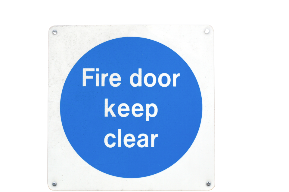 Blue door sign that says Fire door keep clear
